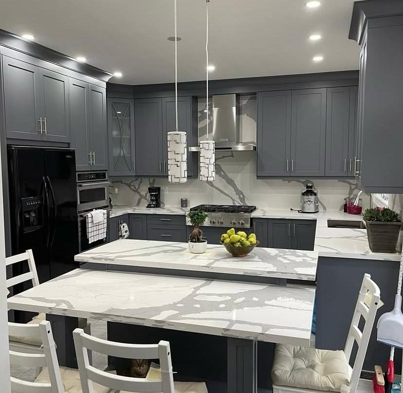 Same kitchen after, charcoal shaker cabinets and quartz island